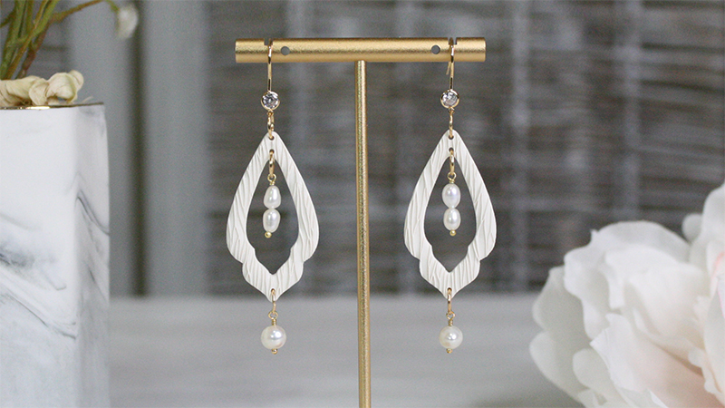 textured white clay earrings adorned with pearls