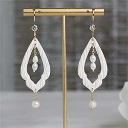 white clay earrings adorned with pearls